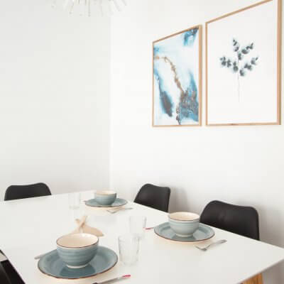 Proyecto de reforma de vivienda en Chamberí II (Madrid) de R de Room. Estar-comedor de estilo escandinavo. Lámpara de techo Sputnik resturada. Láminas de gran formado de Desenio.