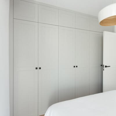 Carpintería interior con cuarterones en gris y blanco. Manillas y pomos negros. Proyecto R de Room.